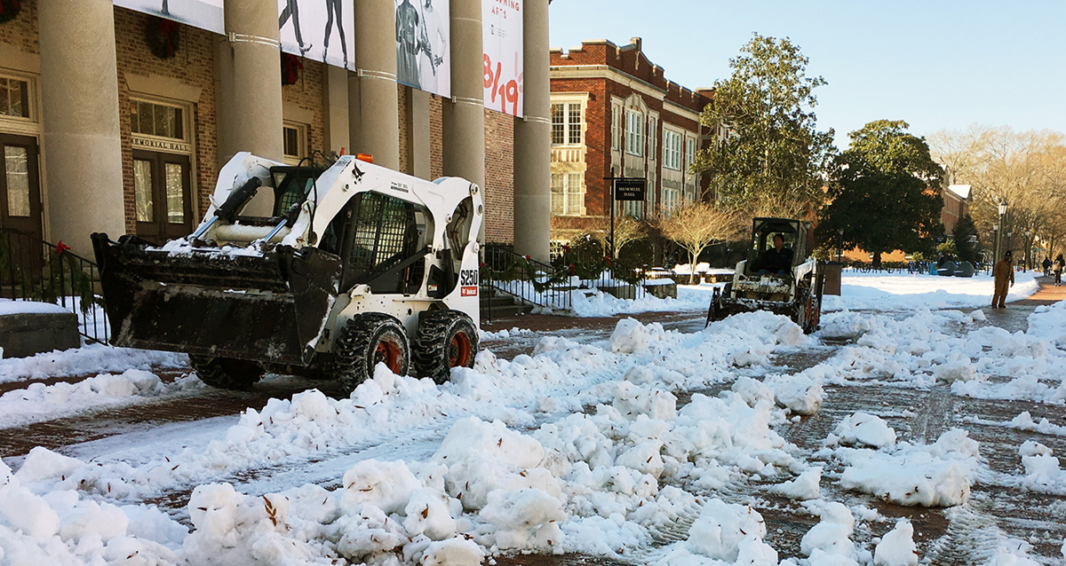 Ground Services staff plow in front of Memorial Hall